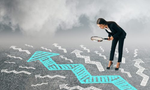 Young woman using magnifier to look at drawn arrow on cloudy sky background. Research and challenge concept